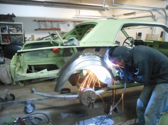 Sean preparing to put a quarter on. Once repairs are made all bare metal is etch primed prior to painting to promote adhesion and stop rust..